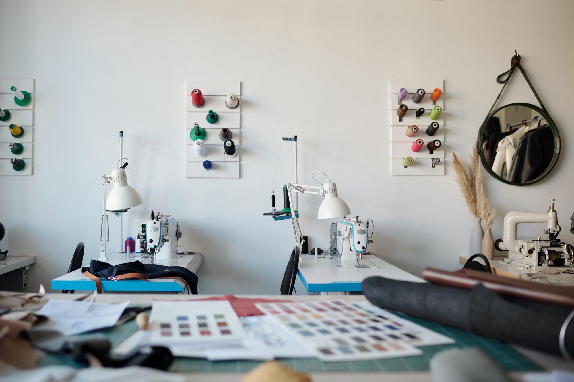 studio workspace with embroidery machine and threads