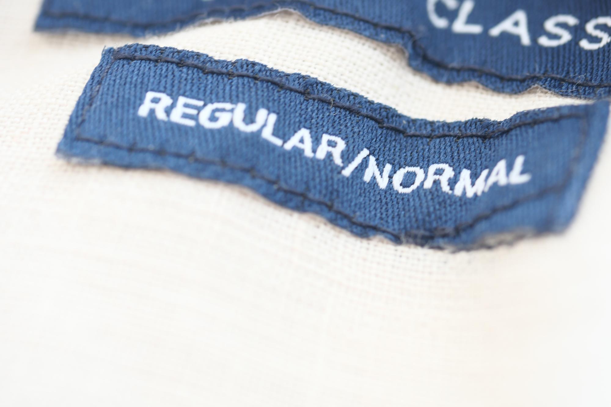 embroidered label sewn on shirt hem